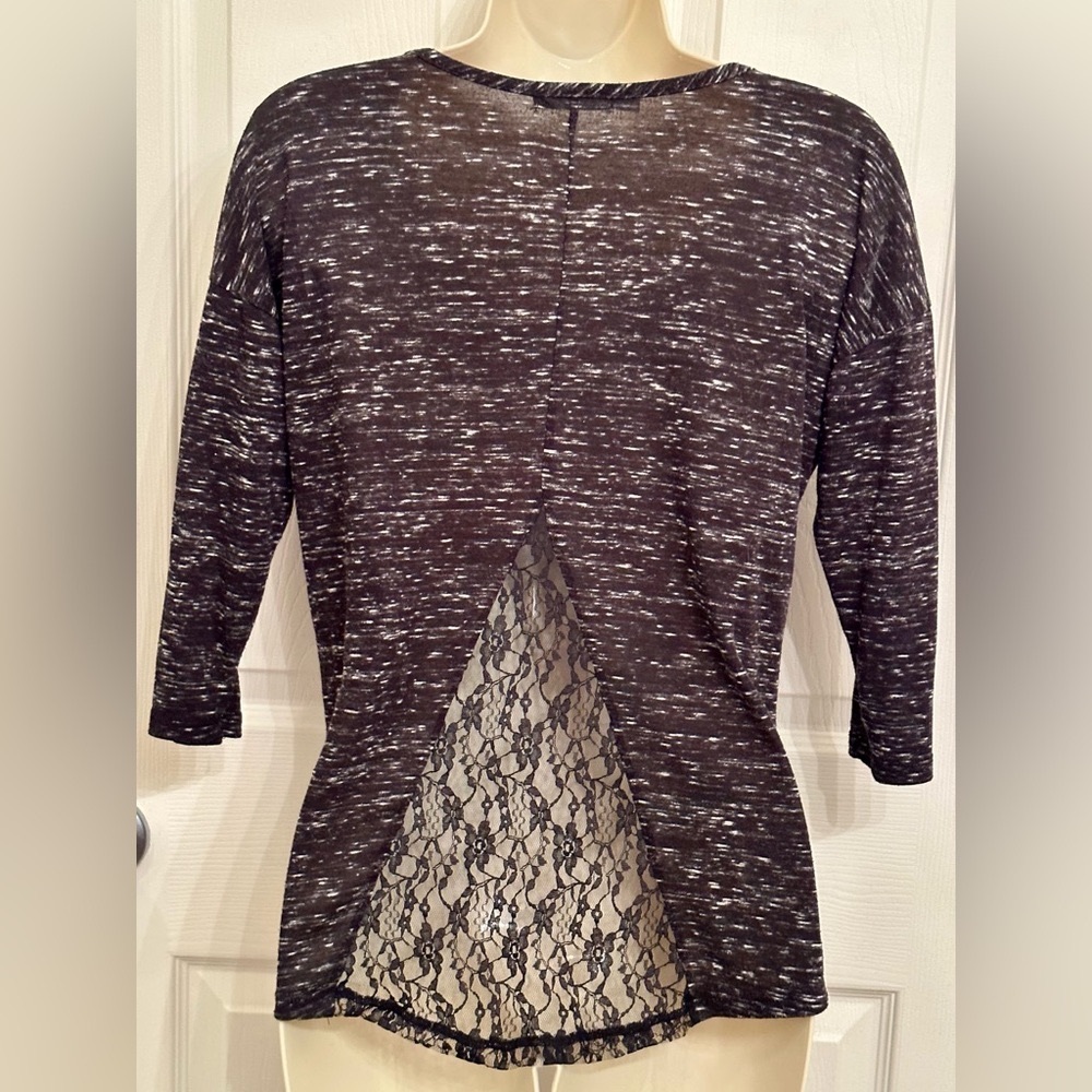 Black/white heathered shirt with lace shoulder and back cutouts.